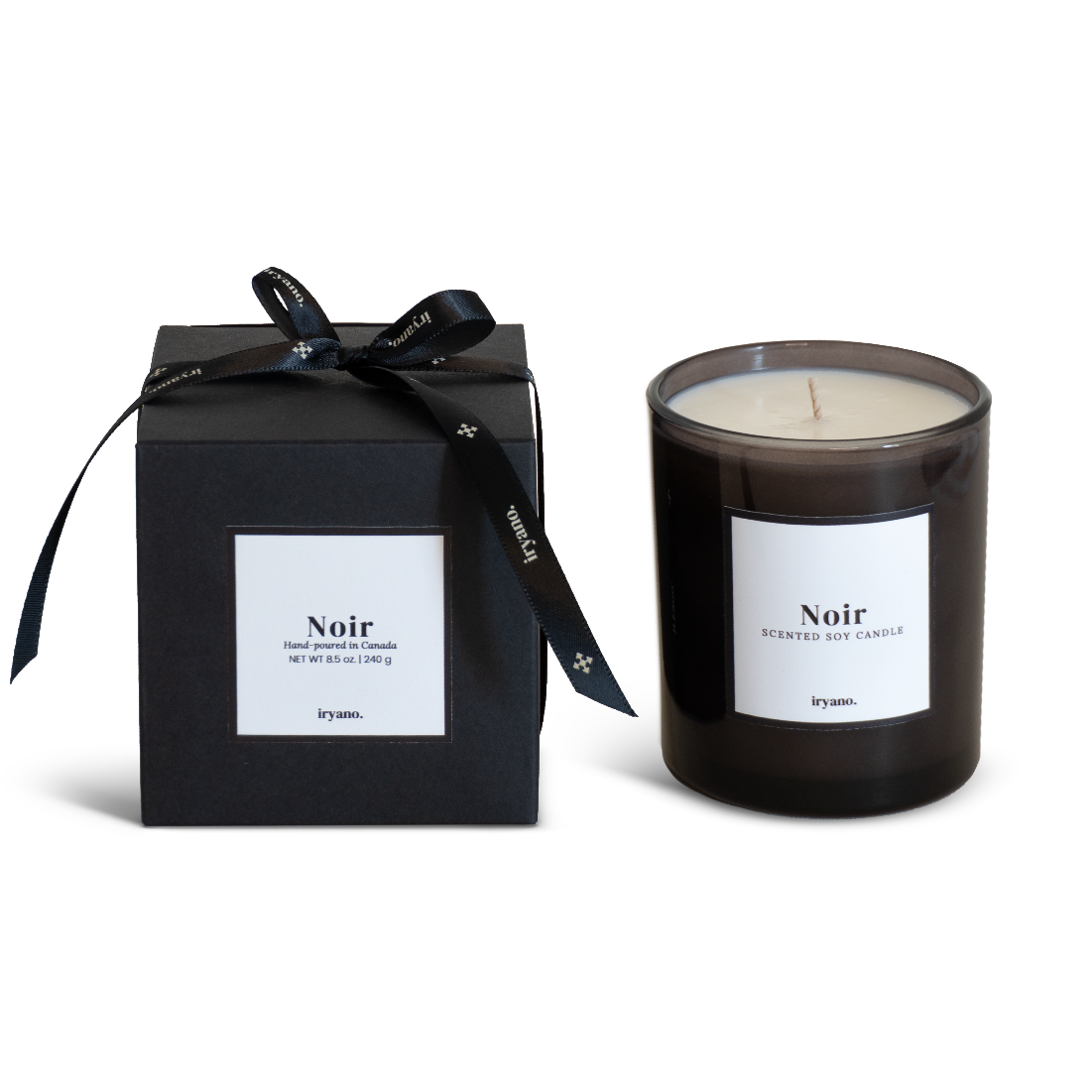 Black candle with 'Noir' label and matching black box on a white background