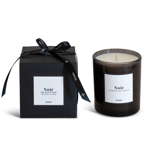 Black candle with 'Noir' label and matching black box on a white background