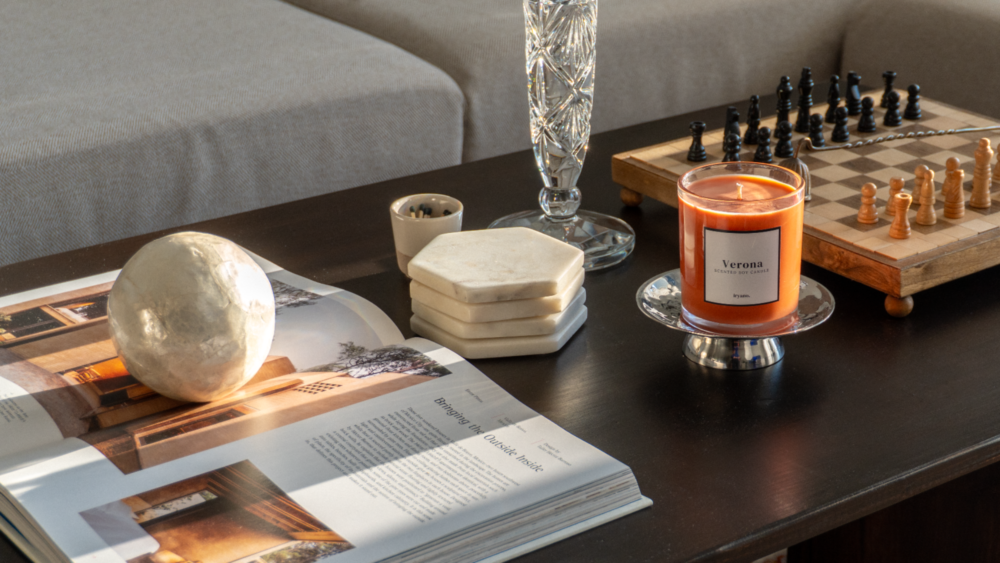 Candle, chessboard, and magazine on a coffee table