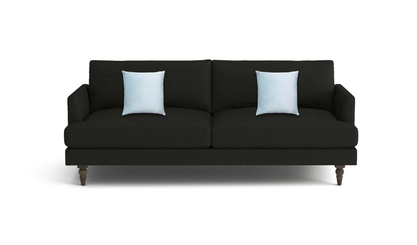 A modern black fabric sofa with two light blue throw pillows, shown from a front-facing perspective on a clean white background.