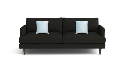 A modern black fabric sofa with two light blue throw pillows, shown from a front-facing perspective on a clean white background.