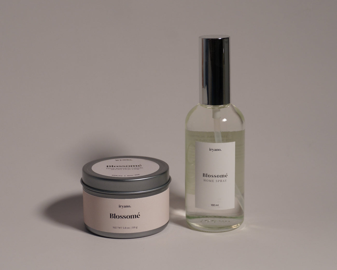 Candle and bottle with 'Bloomeri' branding on a gray background