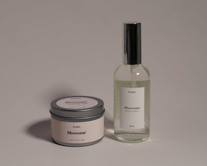 Candle and bottle with 'Bloomeri' branding on a gray background