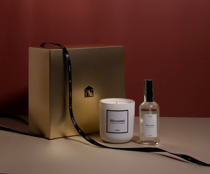 Candle and perfume bottle with a gold gift box on a brown background