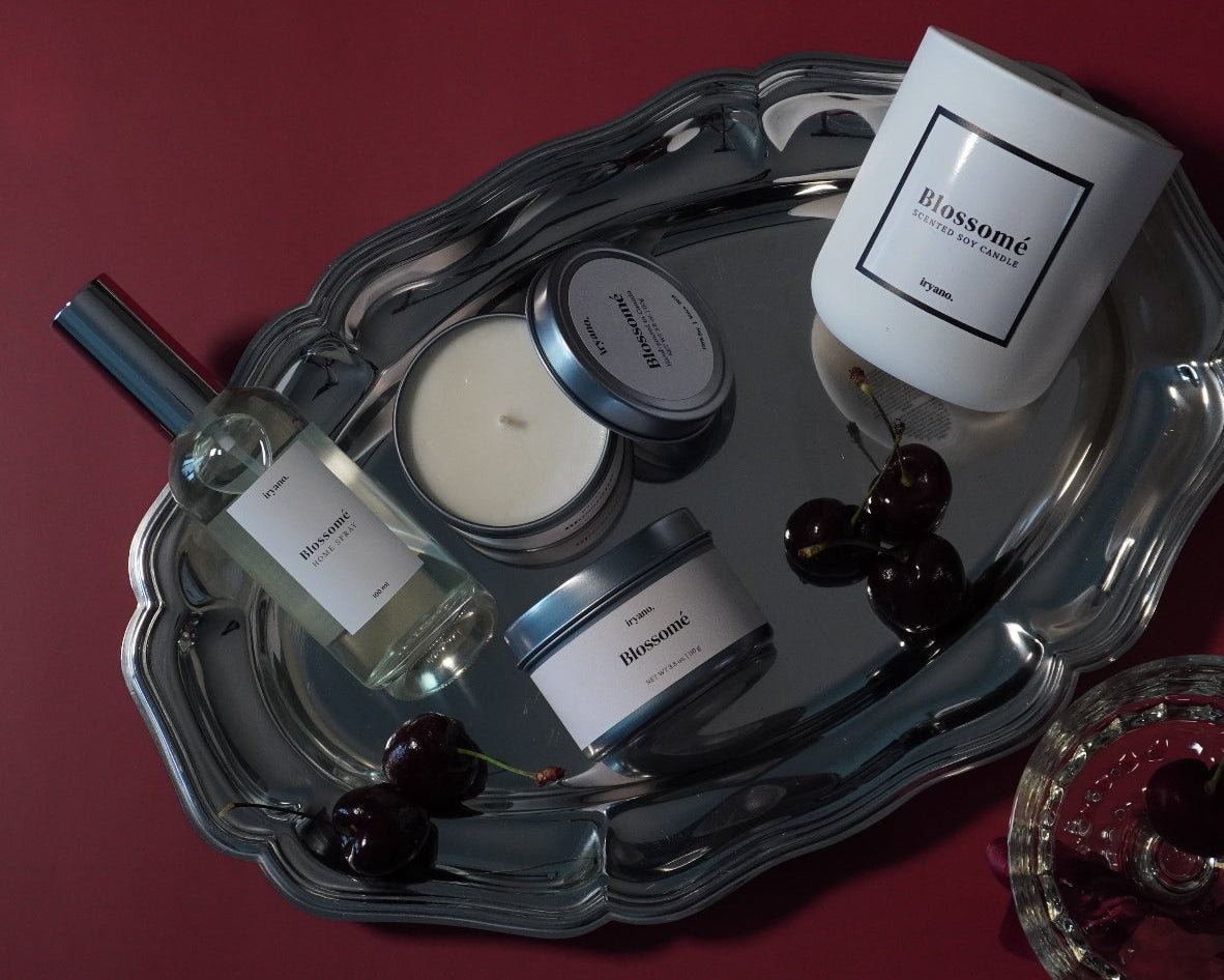 Tray with bottles and candles on a red surface