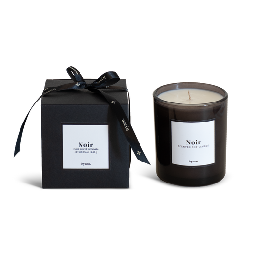 Black candle with 'Noir' label and matching black box on a white background