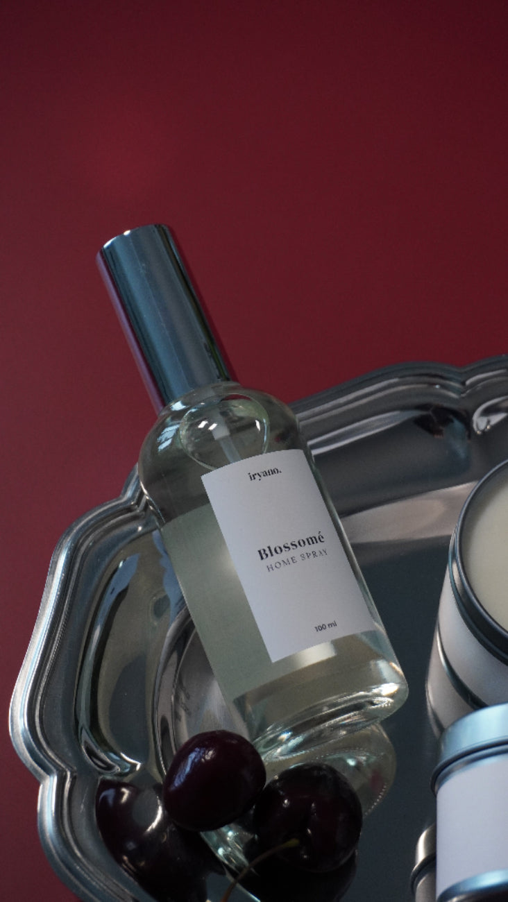 Wine bottle with a label on a metallic stand against a red background