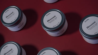 Multiple jars labeled 'Blossom' on a red background
