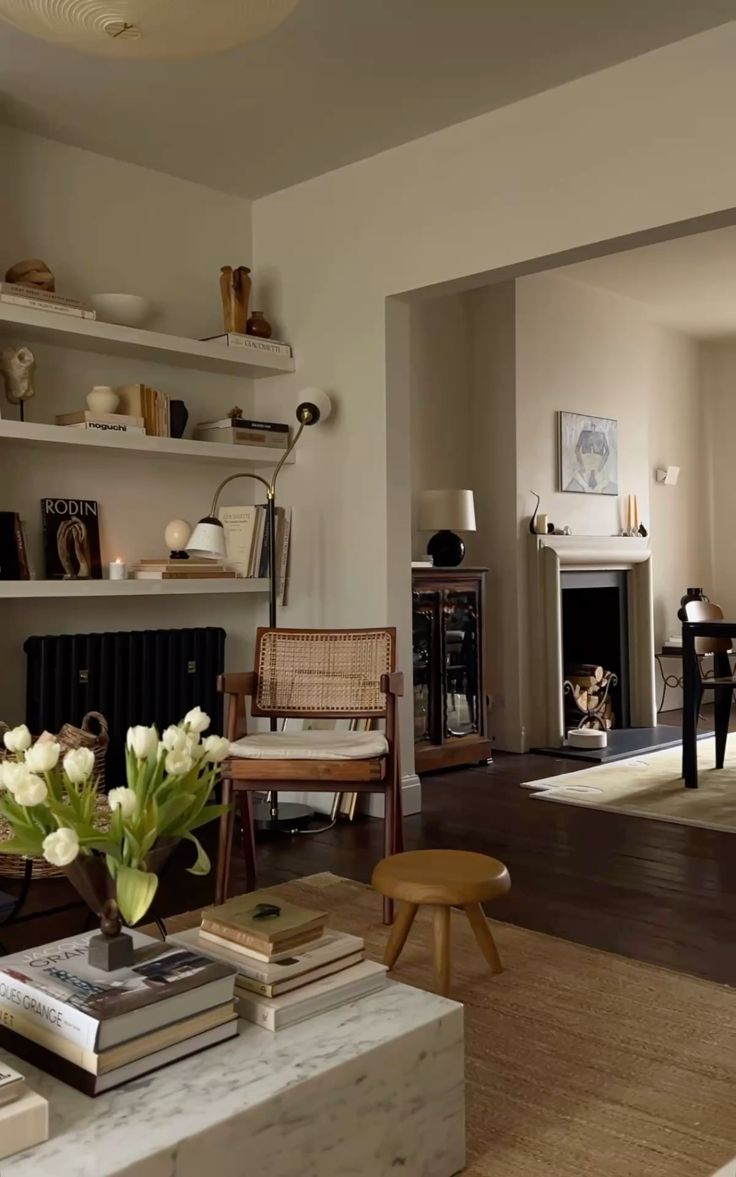 Living room with a fireplace, bookshelf, and wooden chair.