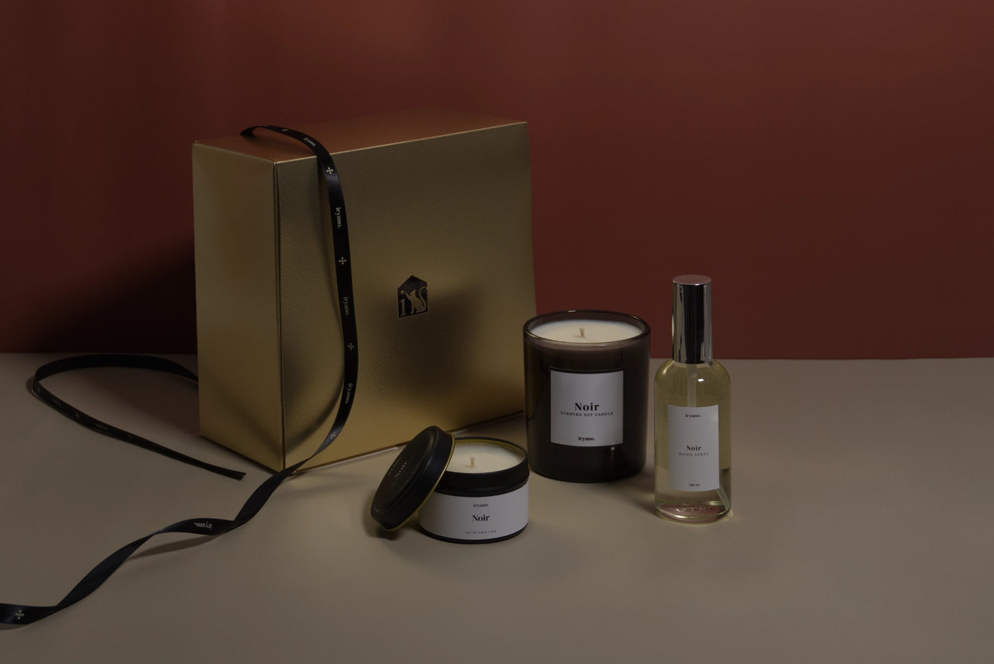 Set of candles and a bottle on a neutral background