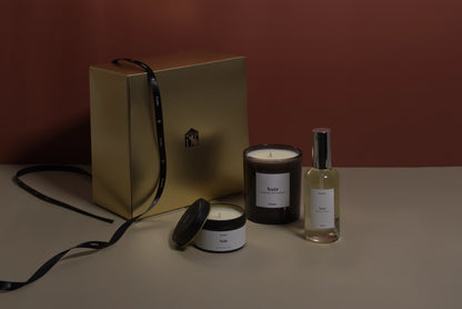 Set of candles and a bottle on a neutral background